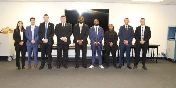 Group of 9 Probation, Parole and Pardon Services agents in business attire.