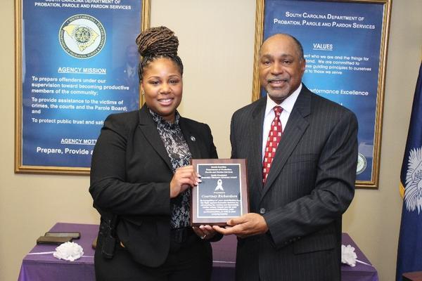 Domestic Violence Agent Courtney Richardson receiving the Keith Crossland Award.