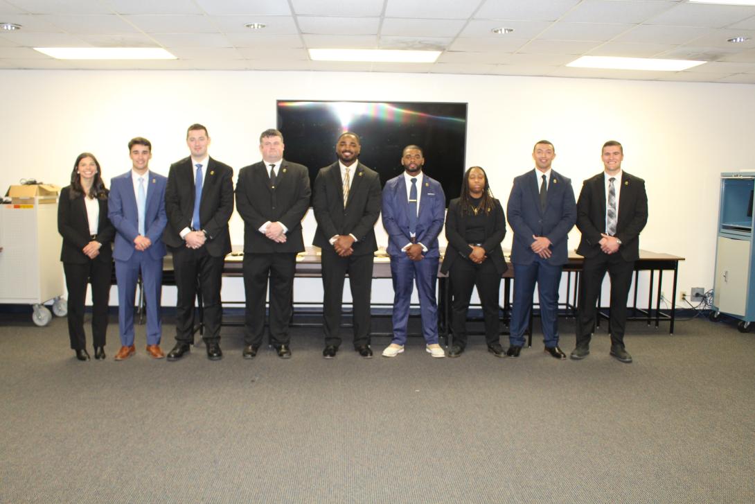 Group of 9 Probation, Parole and Pardon Services agents in business attire.